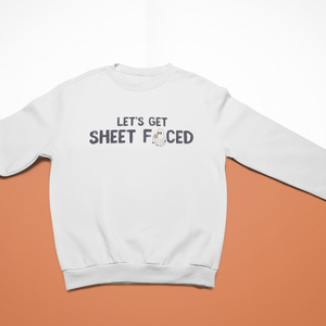 White cozy sweatshirt with the playful Halloween-themed text "Let's Get Sheet Faced" and a small ghost illustration, perfect for festive or casual wear.