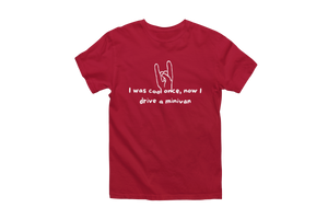 A humorous red T-shirt featuring white text that reads, "I was cool once, now I drive a minivan." Above the text, there's an illustration of a hand making the rock 'n' roll gesture with the index and little fingers extended. Celebrate your transition into minivan life with this "I Was Cool Once, Now I Drive a Minivan" Short Sleeve T-Shirt.