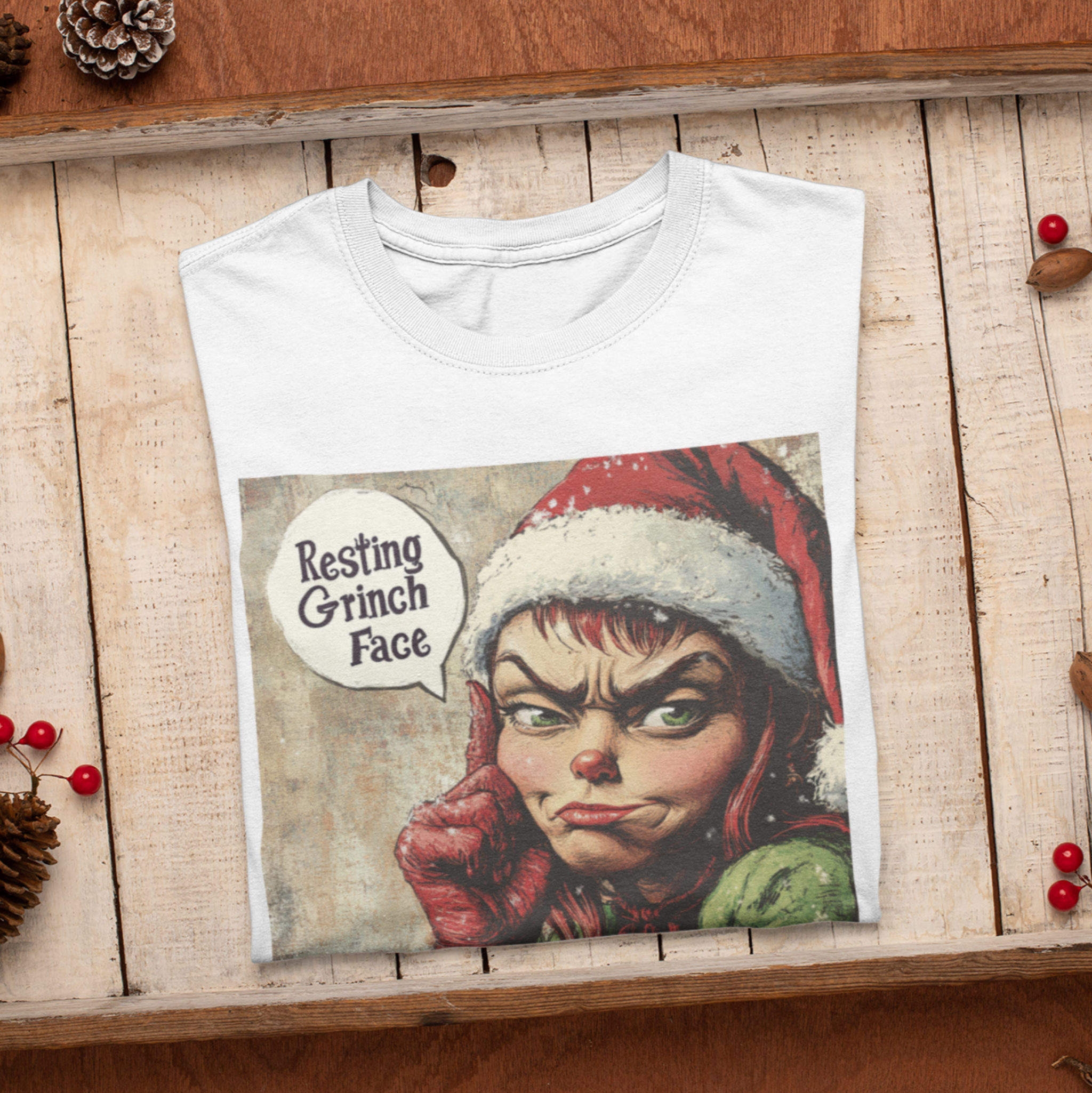 Folded Festive t-shirt with a 'Resting Grinch Face' graphic, perfect for adding humor and sass to your holiday wardrobe 