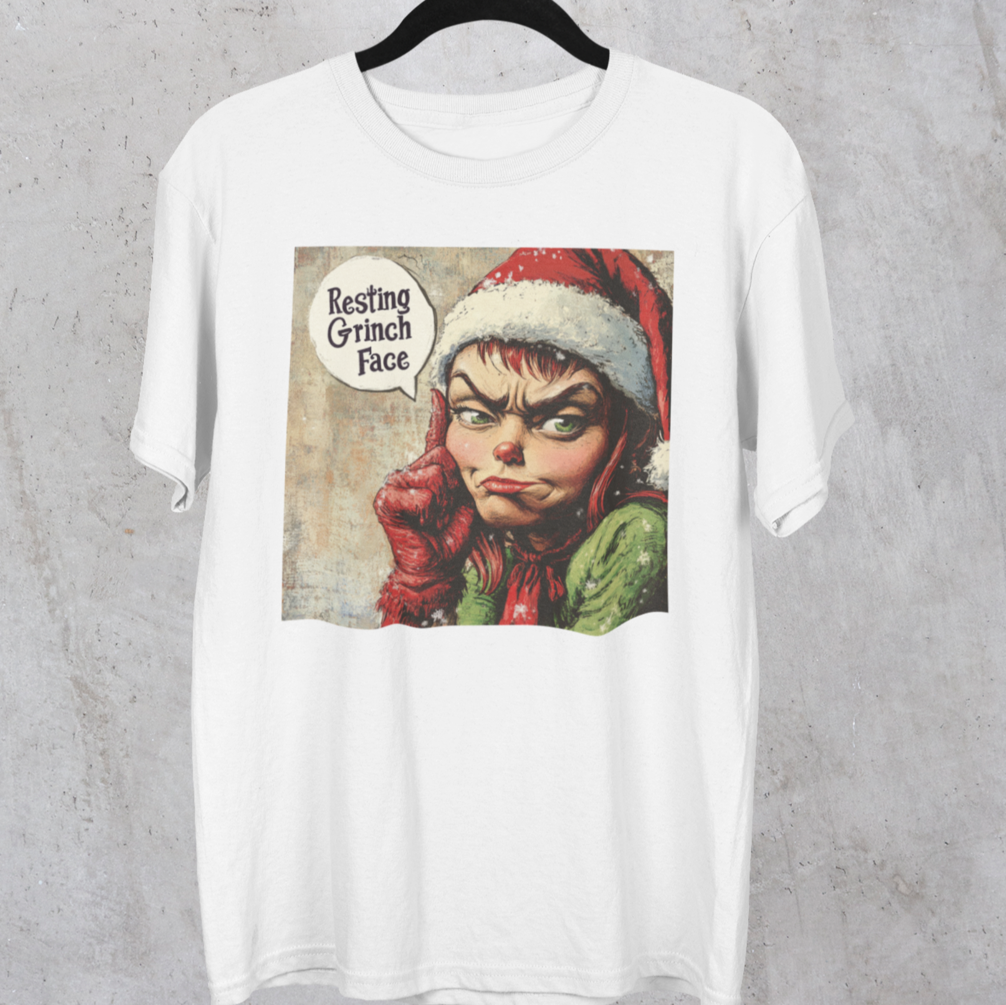 Hanging Festive t-shirt with a 'Resting Grinch Face' graphic, perfect for adding humor and sass to your holiday wardrobe