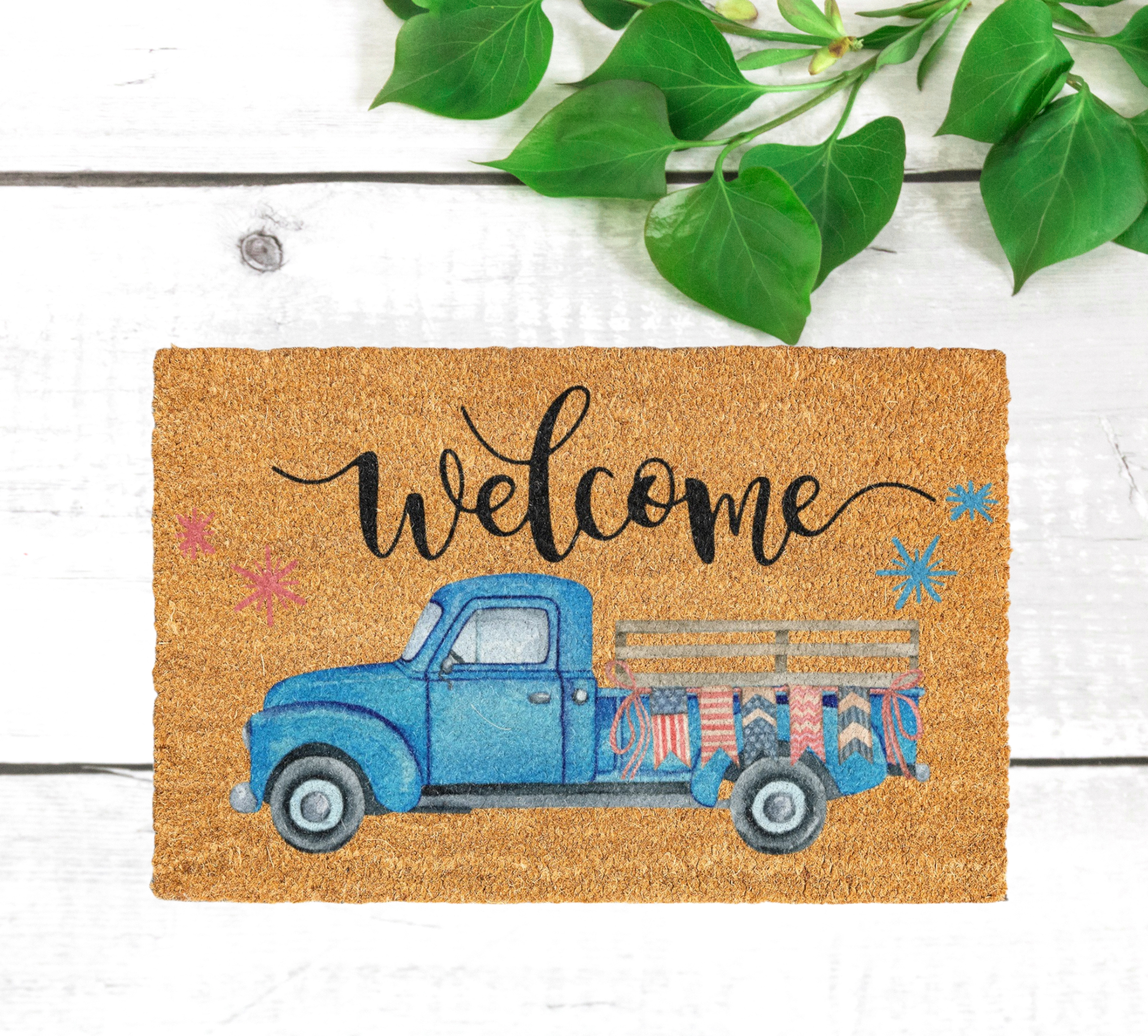 Coconut coir welcome mat featuring a charming vintage blue truck design, perfect for adding a touch of style and warmth to any home decor