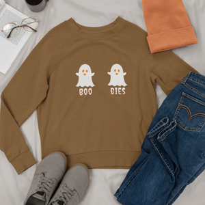 Brown cozy Halloween sweatshirt featuring two cute ghost illustrations with the playful text "BOO BIES," styled with jeans, gray sneakers, and a beanie, perfect for casual festive wear.