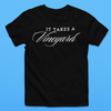 A black t-shirt with the phrase "It Takes a Vineyard" Short Sleeve T-Shirt printed on the front in white. The word "Vineyard" is styled in an elegant, cursive font. Perfect for those who celebrate motherhood and enjoy wine, this shirt offers both comfort and style against a solid light blue backdrop.