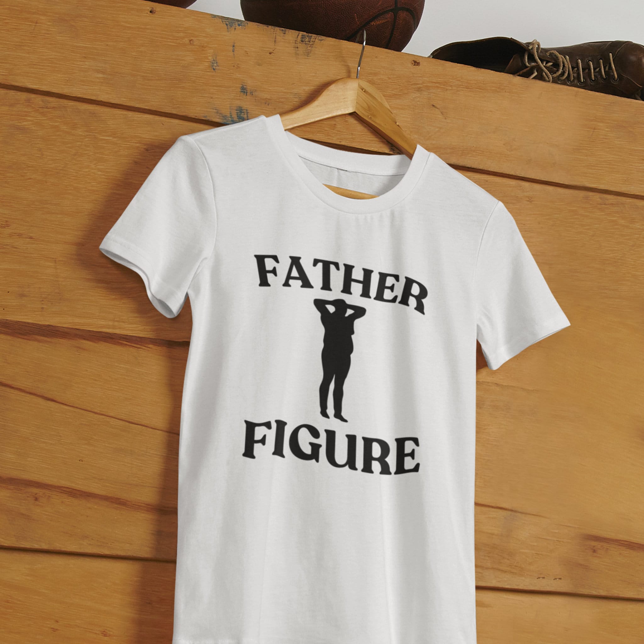 A white shirt hanging with the phrase 'Father Figure,' making it a funny and custom Father's Day gift for dads. Perfect for those looking for unique and humorous dad shirts.