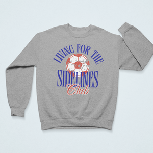 Gray cozy sweatshirt with the text "Living for the Sidelines Club" featuring a worn soccer ball graphic, perfect for soccer fans or sports supporters.