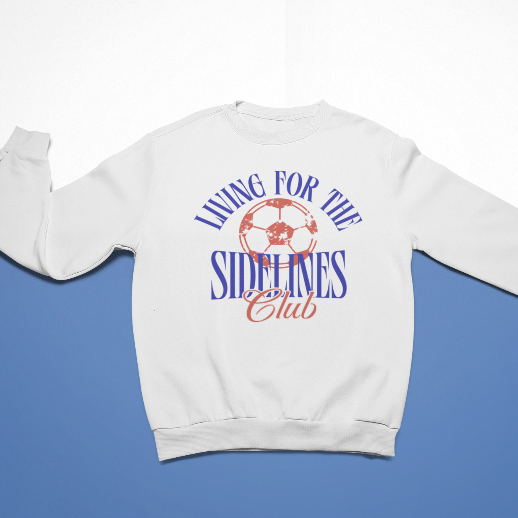 White cozy sweatshirt with the text "Living for the Sidelines Club" featuring a worn soccer ball graphic, perfect for soccer fans or sports supporters.