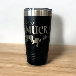 Black tumbler with silver text that reads "Zero Amucks Given," featuring silhouettes of three witches' hairstyles, perfect for Halloween-themed drinkware.